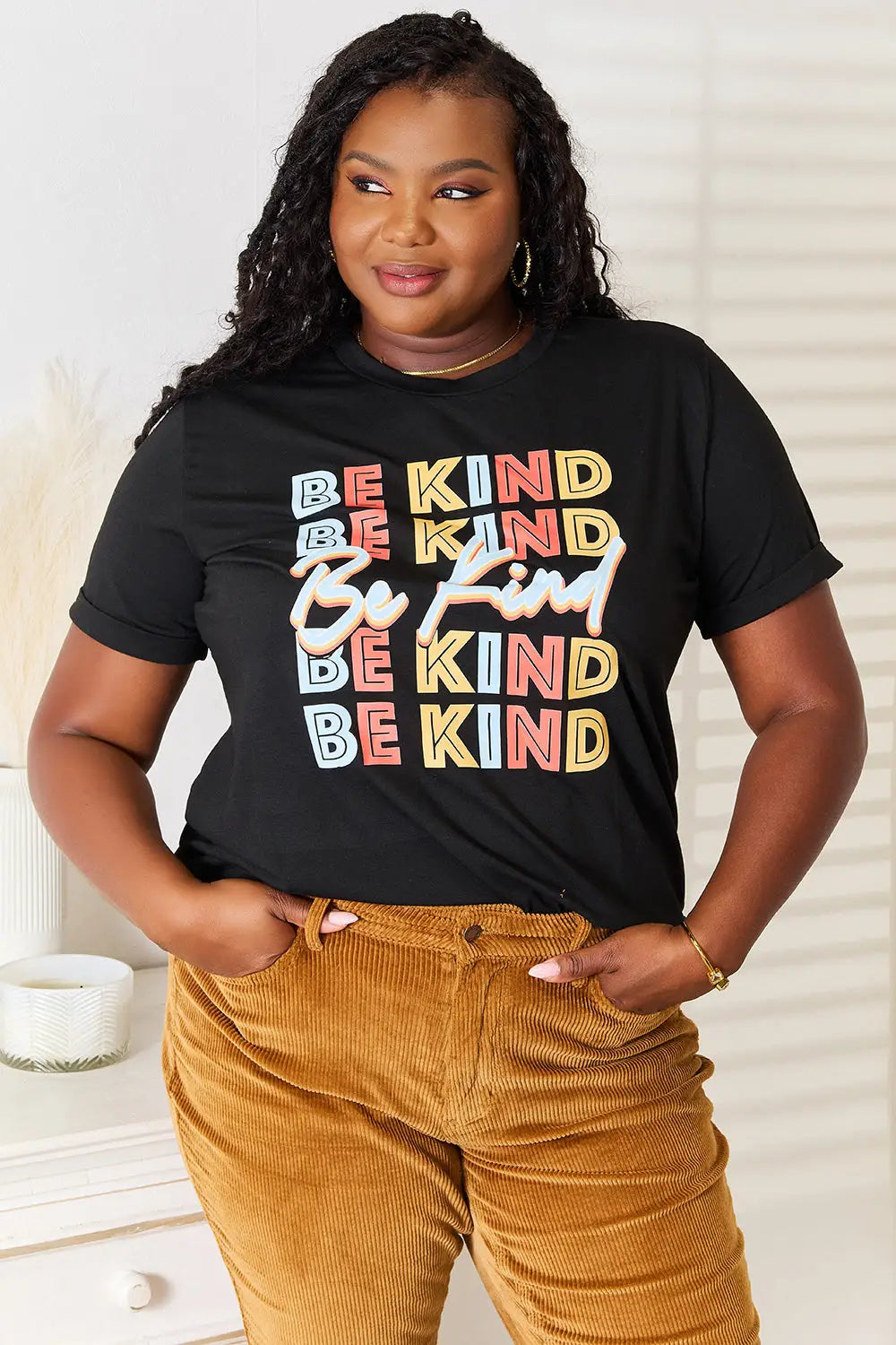 Black short-sleeved Be Kind graphic round neck T-shirt with colorful print