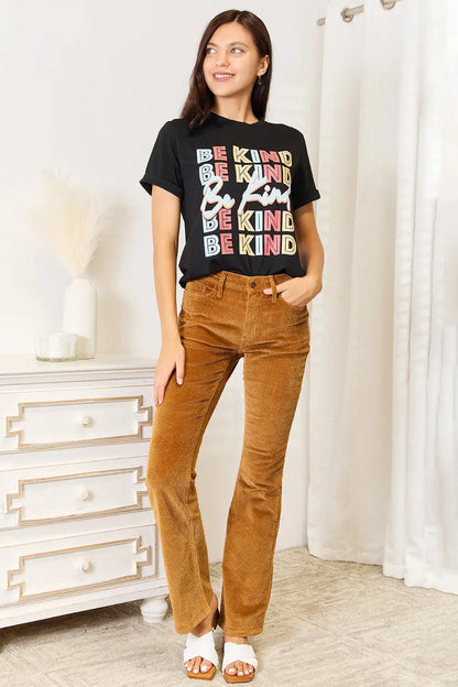 Women’s black short-sleeve round neck T-shirt with BE KIND graphic and brown flare corduroy pants
