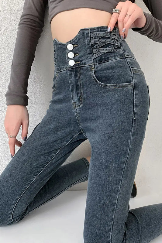 Vintage high waist skinny pencil jeans with three white buttons and criss-cross stitching