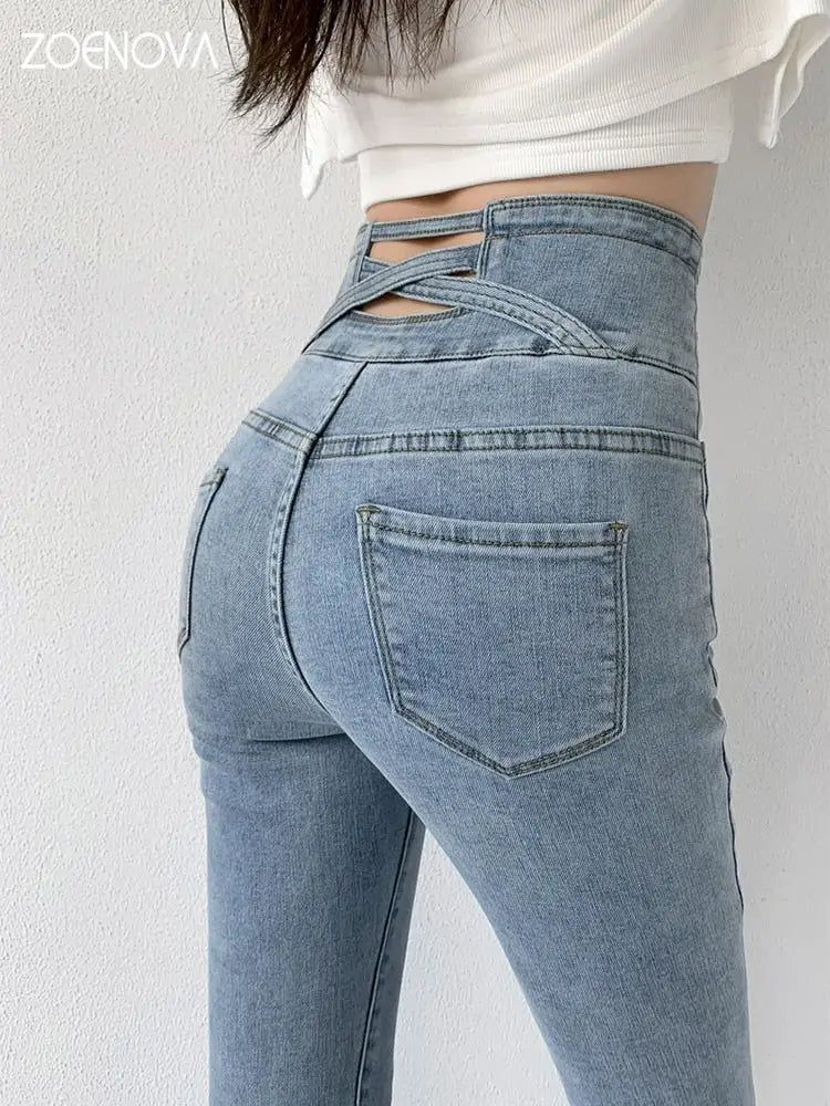 Light wash high-waisted skinny pencil jeans with criss-cross back straps for women