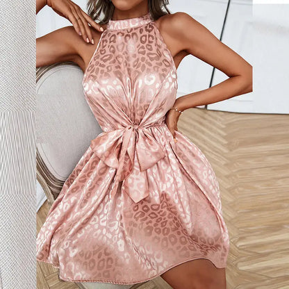 Pink satin sleeveless halter neck dress with leopard print and front bow for stylish occasions