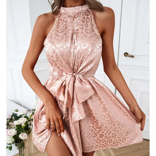 Pink satin sleeveless halter neck mini dress with leopard print and bow detail