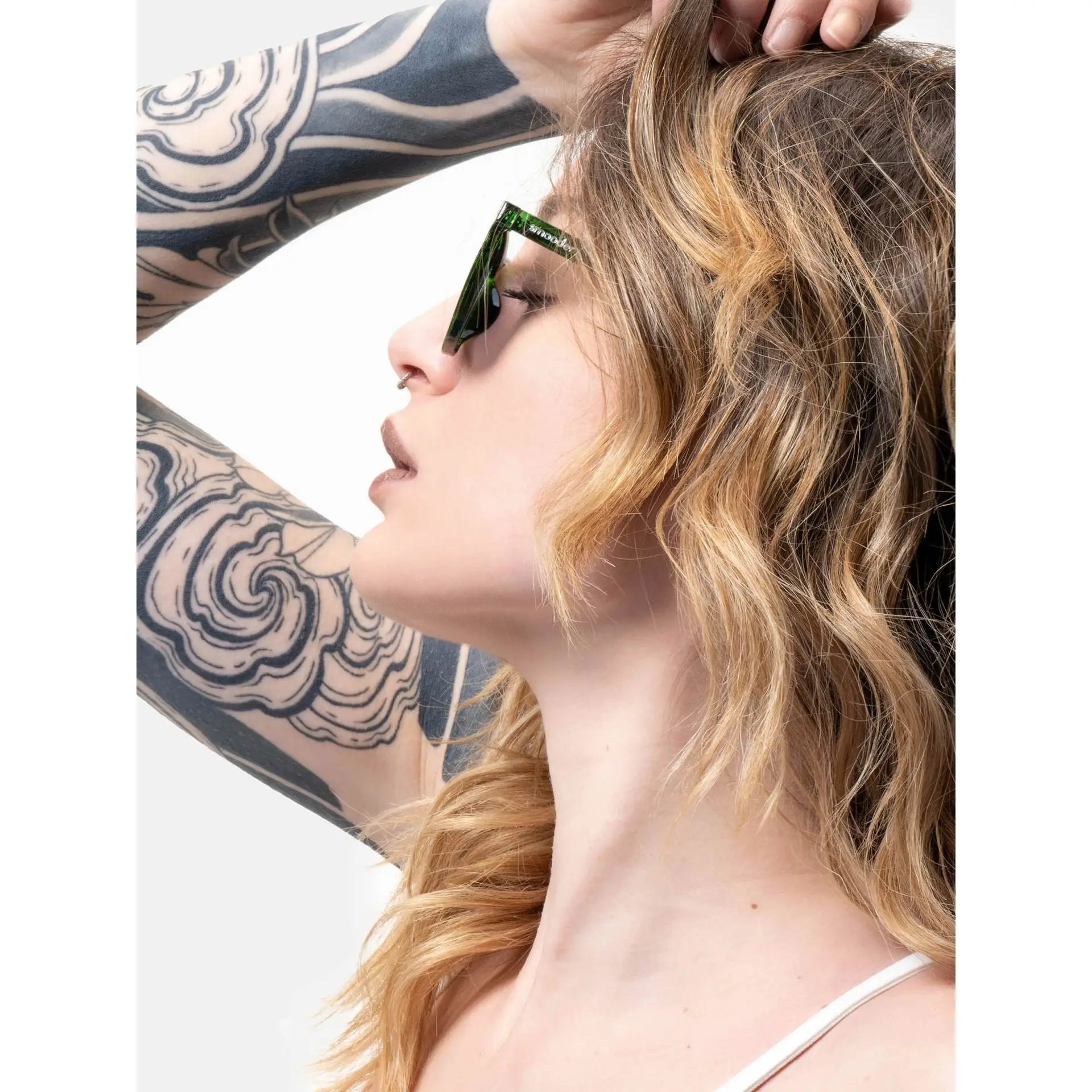 Woman wearing stylish green sunglasses with tattoo sleeve showcasing Smooder Sunglasses Superior Green Sonora_X023