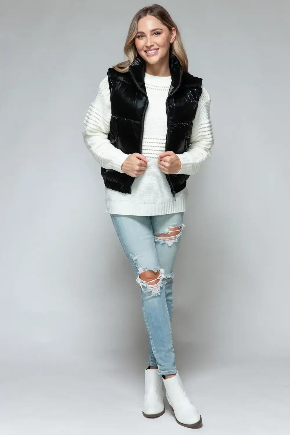 Black faux fur vest with white trim and zipper closure featuring fine fur lining quilted design