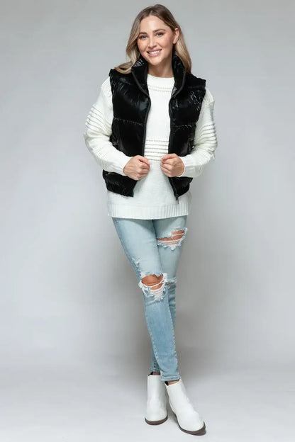 Black faux fur vest with white trim and zipper closure featuring fine fur lining quilted design