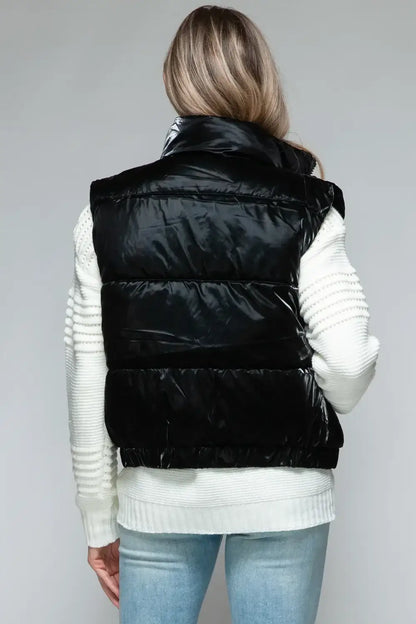 Black quilted puffer vest with white ribbed trim and fine fur lining for warmth