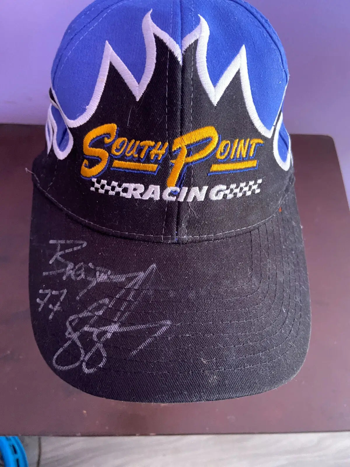 Black and blue flame racing hat signed by Brendan Gaughan NASCAR with embroidered text