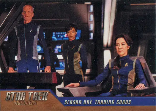Three Starfleet officers on a starship bridge in Star Trek Discovery distribution promo card