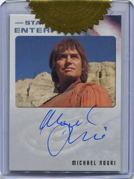 Autograph card of Michael Nouri as Syrran in orange shirt against rocky backdrop