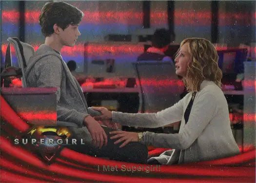 Trading card of two people conversing with Supergirl logo and rainbow foil board design
