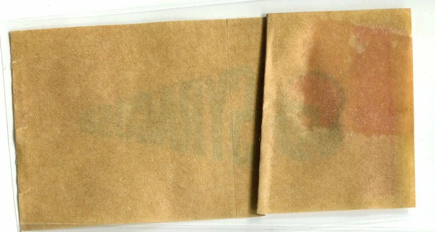 Folded, stained, and aged paper of Syracuse Orangemen 1964 pennant sticker decal