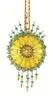 Yellow circular pendant with green beads on gold chain from Cracker Box Wintertime Artistry ornament