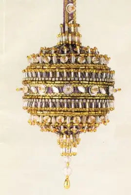 Ornate cracker box Christmas ornament with gold purple accents and teardrop bead