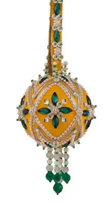 Ornate yellow and green beaded Christmas ornament with emerald stones from Cracker Box holiday festival kit