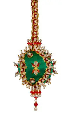 Vibrant green cracker box Christmas ornament with gold, red, and pearl beadwork for holiday festival
