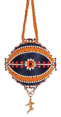 Ornate dark blue egg-shaped ornament with orange, red, white beads and golden figure charm for Cracker Box ornament kits