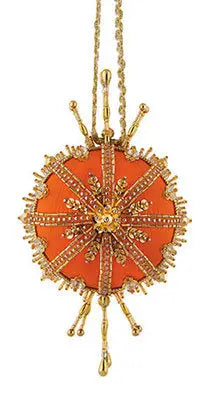 Ornate orange and gold pendant with starburst design from Cracker Box Christmas Ornament Kit