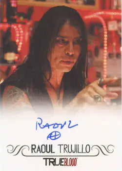 Autographed Raoul Trujillo trading card on a reddish background for collectors