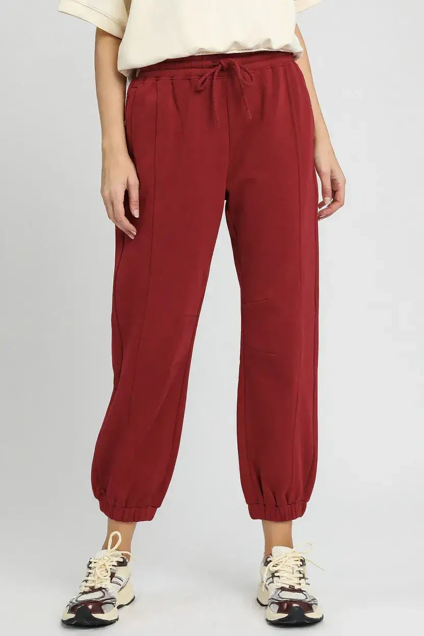 Red fleece jogger pants with drawstring waist and elastic ankles for a comfortable fit