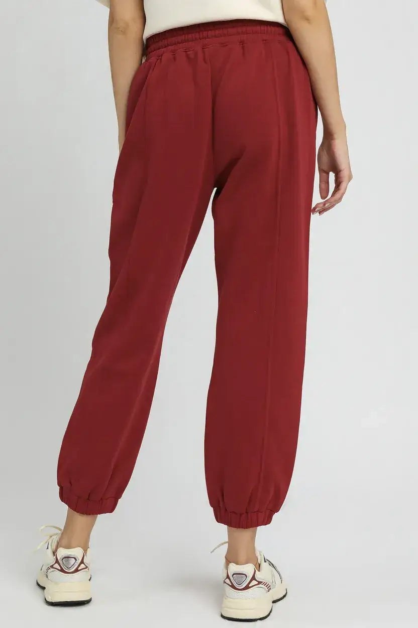 Maroon fleece jogger pants with elastic waistband and drawstring for a comfortable fit