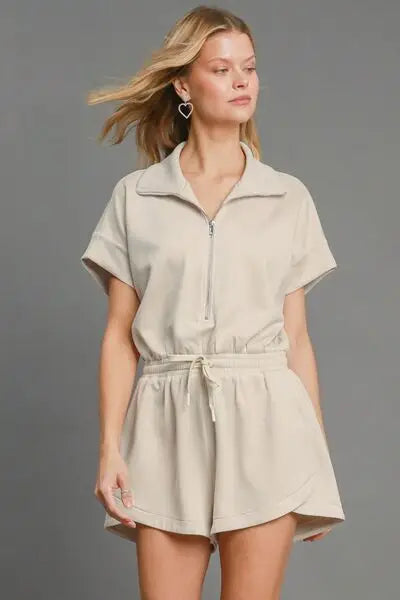 Light beige short-sleeved dolman sleeved romper with half-zip and drawstring waist