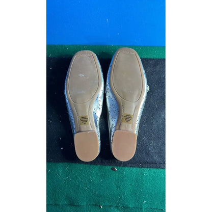 Silver ballet flats with perforated floral designs from Unisa Gold Loafers collection