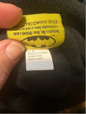 Black Batman beanie hat with yellow logo tag, perfect for Harley Quinn fans