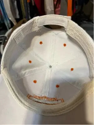 White unisex Harley-Davidson hat with orange eyelets and embroidered inner band