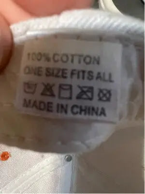 White cotton Harley-Davidson hat with care instructions and country of origin display