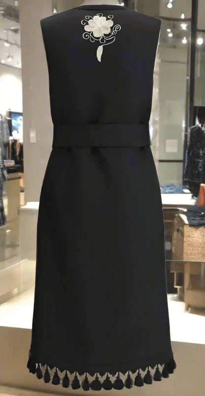 Black sleeveless embroidered long vest with white floral embroidery and tasseled hem