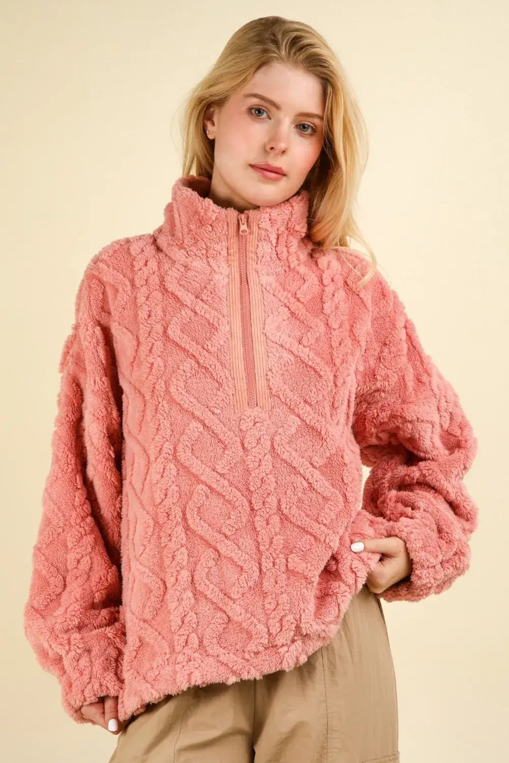 Pink fuzzy fleece half zip sweater with cable pattern, gold zipper, and buttons