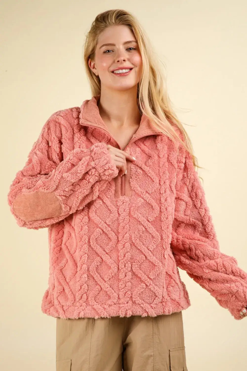 Pink cable knit sherpa jacket with a half zip and fuzzy fleece half design