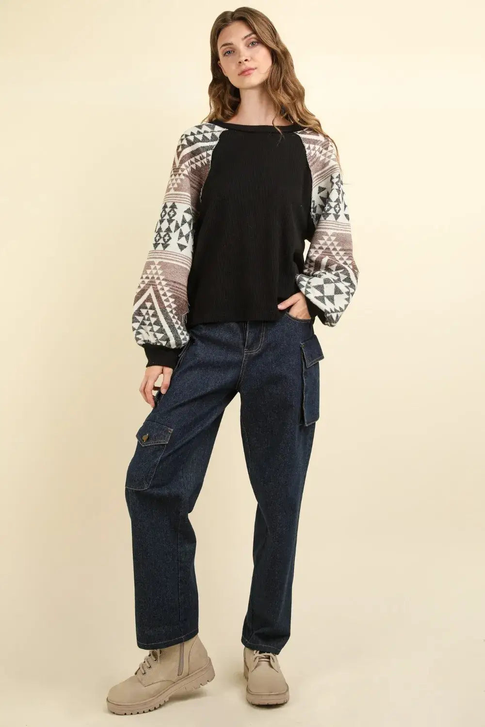 Black and white printed long sleeve round neck knit top with patchwork design and beige boots