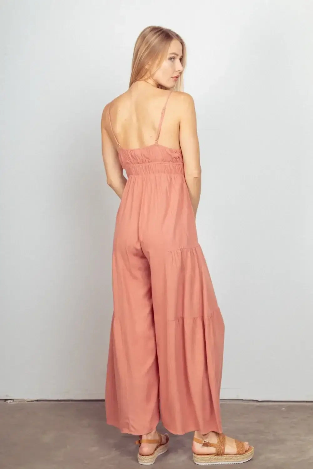 Peach wide leg jumpsuit with open back and adjustable straps in lightweight fabric