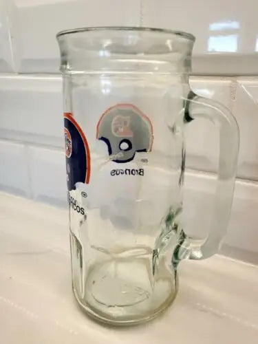 Clear glass mug featuring Denver Broncos NFL logo for vintage sports collectors