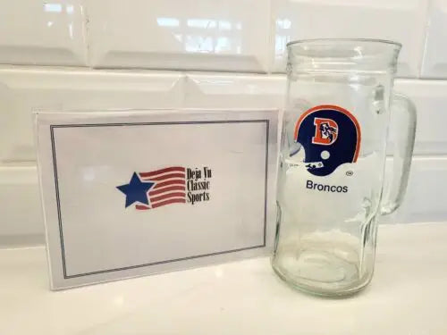 Vintage 1980s Denver Broncos NFL glass mug featuring classic Fisher Peanuts design