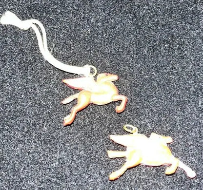Two winged horse ornaments from Vintage Celluloid Mobil Oil Red Pegasus toy lot