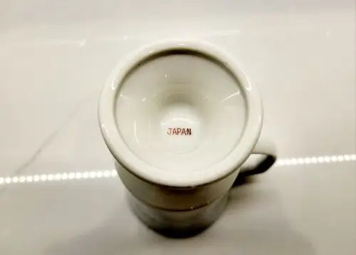 White ceramic mug with JAPAN printed inside, part of the Red Coats Revolutionary collection