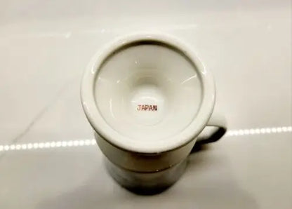 White ceramic mug with JAPAN printed inside, part of the Red Coats Revolutionary collection
