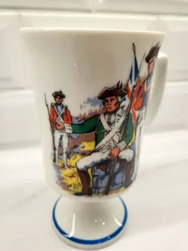 White porcelain mug featuring Red Coats Revolutionary War soldiers, vintage historic design
