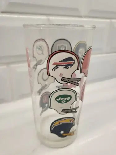 Glass cup featuring NFL American Football Conference eastern division helmets