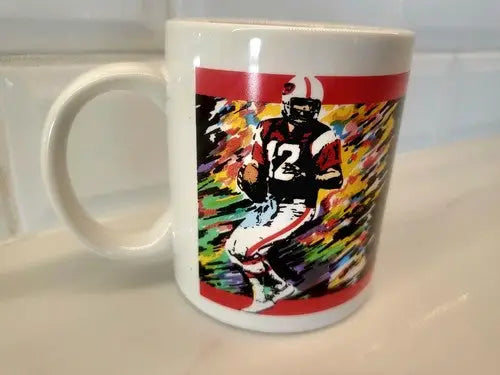 White mug featuring a football player graphic, Joe Namath Canton Ohio Pro design