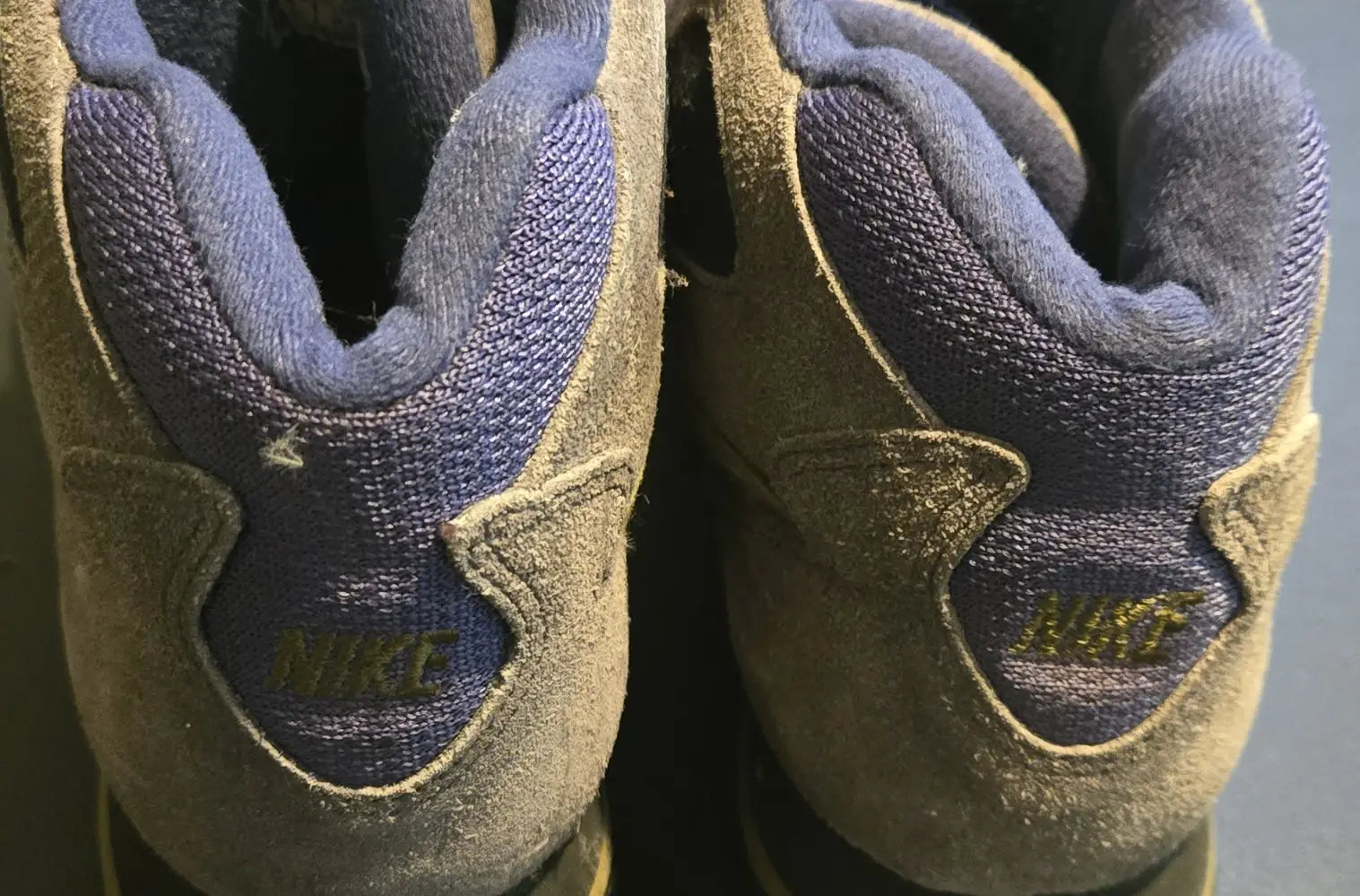 Pair of gray and blue suede Nike ACG hiking boots from vintage conditions gear collection