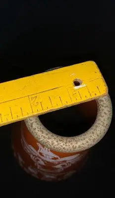 Yellow wooden ruler on orange ceramic pot with Texas Longhorns national champions theme