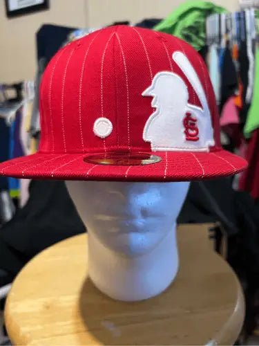 Red baseball cap with white pinstripes and Saint Louis Cardinals logo with StL text