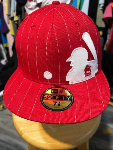 Red baseball cap with white pinstripes and Saint Louis Cardinals batter logo