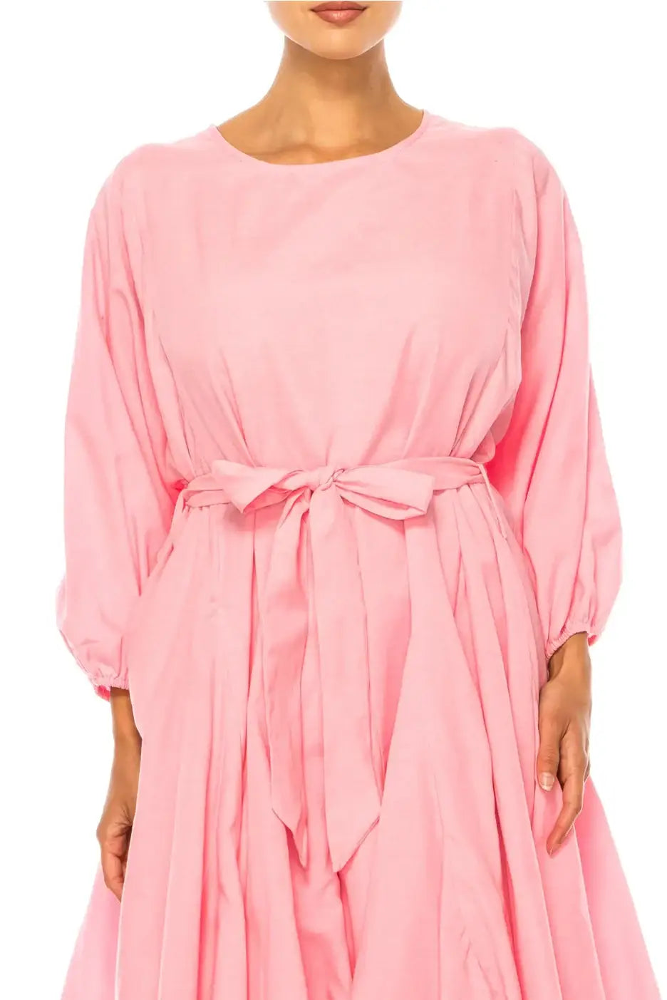 Woman wearing Vivid Apparel pink belted godet knee-length day dress