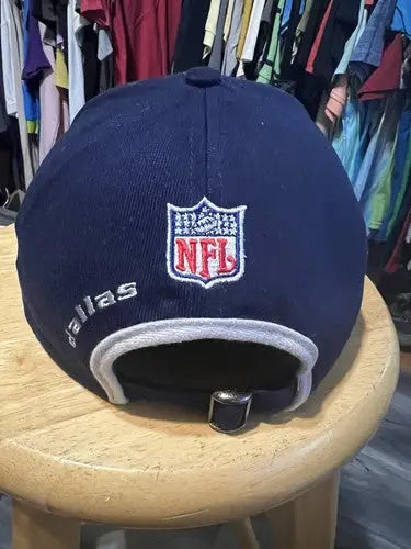 Navy blue Dallas Cowboys hat with NFL logo and embroidered Dallas on the back