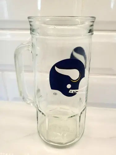 Clear glass beer mug featuring Minnesota Vikings logo, perfect for collectors and fans