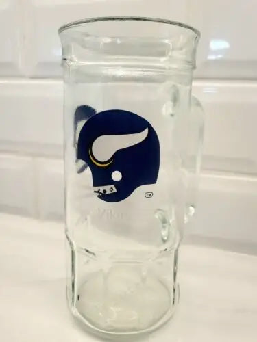 Clear glass beer stein featuring Minnesota Vikings logo and a Viking helmet design